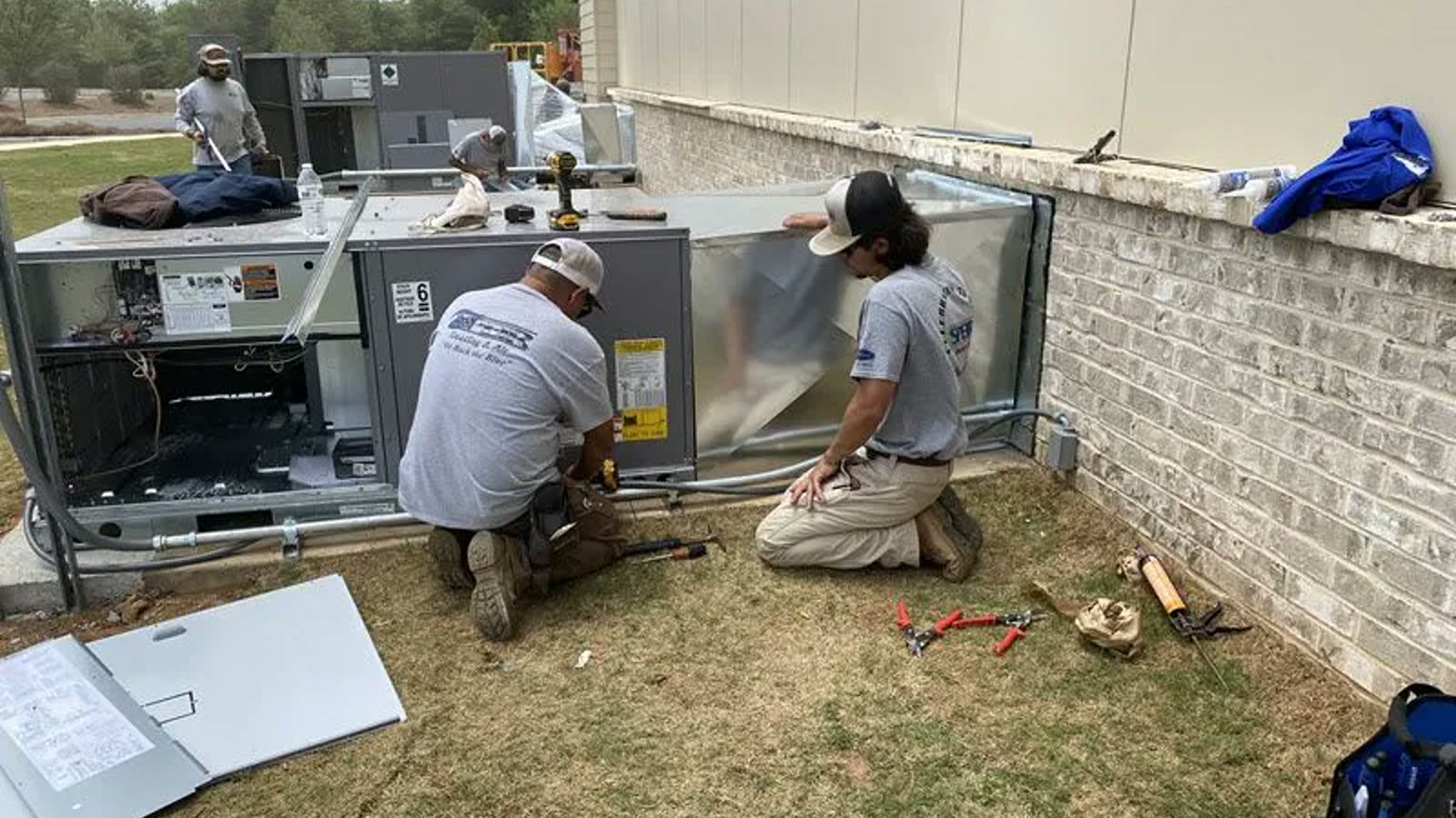 HVAC technician inspecting an outdoor air conditioner in Peoria